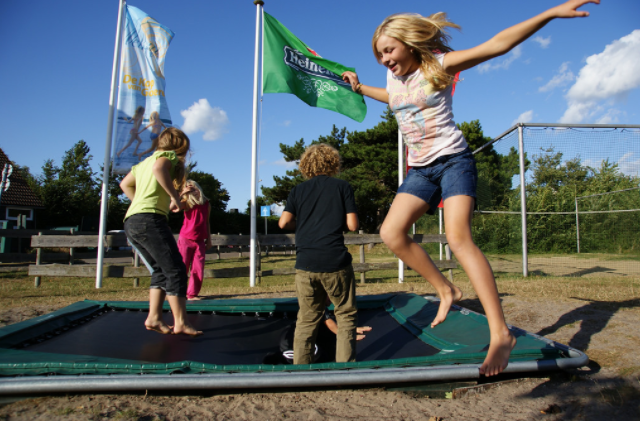Family Jumping in a big trampoline